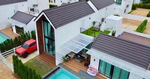 an aerial view of a house with a red car on the porch at Colmar PoolVilla Khao Yai in Wangkata