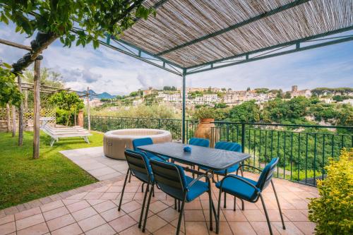 a patio with a table and chairs and a view at Villa San Lorenzo in Scala
