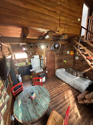 a room with a table and a couch and a bed at CABAÑA STANDARD pileta-cochera in Río Ceballos