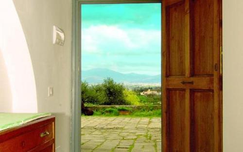 an open door with a view of a patio at Le Corti - Agriturismo Olio e Vino in Lastra a Signa