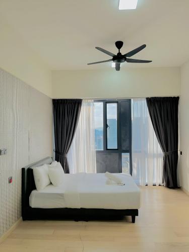 a bedroom with a bed with a ceiling fan at Suites Apartment By Star Residences in Kuala Lumpur