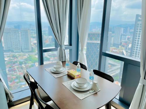 a table in a room with a view of a city at Suites Apartment By Star Residences in Kuala Lumpur