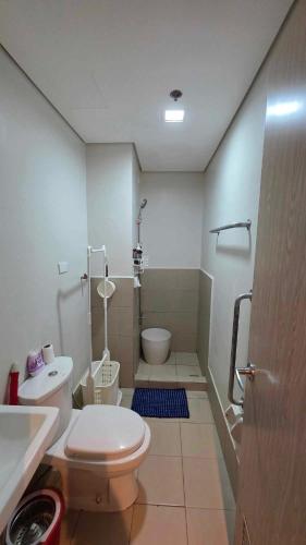 a bathroom with a toilet and a sink at Andele's Place in Marilao