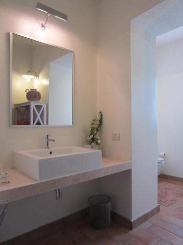 a bathroom with a large white sink and a mirror at IL CASALE DEGLI ULIVI- Splendido casale panoramico con piscina a 30 min da Roma GRA in Calvi dellʼ Umbria