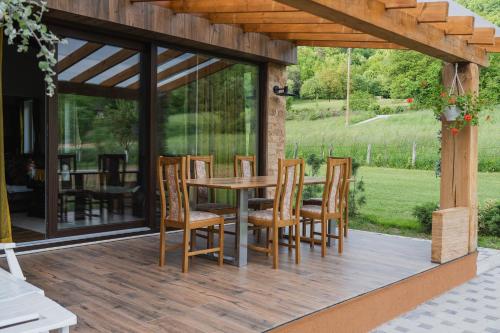 a patio with a table and chairs on a deck at Mali Wimbledon in Visoko