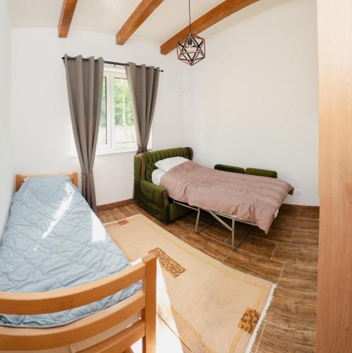 a living room with a bed and a couch at Mali Wimbledon in Visoko