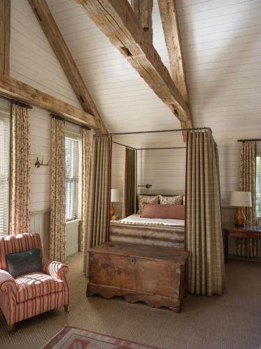 a bedroom with a bed and a couch and a chair at Eleven Scarp Ridge Lodge in Crested Butte