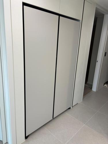 a row of white closet doors with black trim at 광명 스위트하우스 in Gwangmyeong