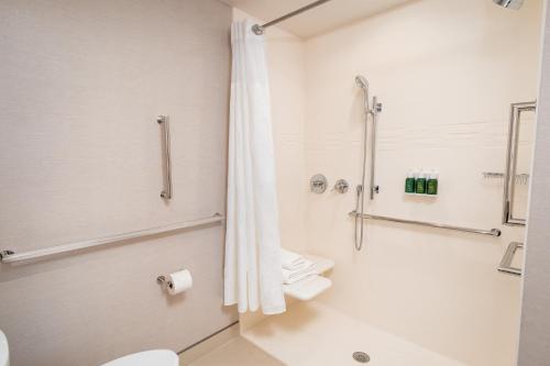 a bathroom with a toilet and a shower at Residence Inn by Marriott Grand Rapids Downtown in Grand Rapids
