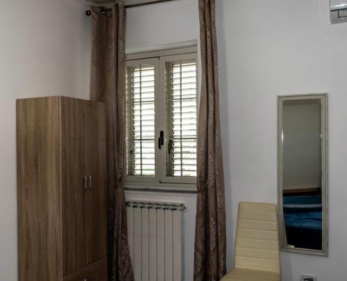 a room with a door and a window and a staircase at La Culla B&B in SantʼEufemia Lamezia