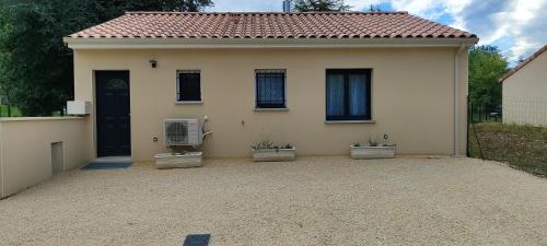a house with two plants in the front of it at maison in Saint-Laurent-en-Royans