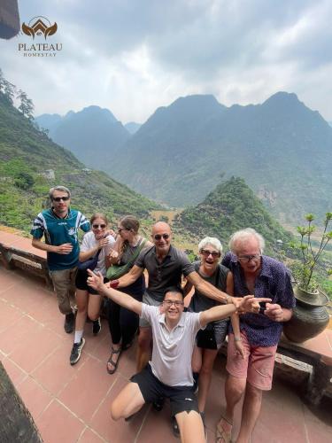 a group of people posing for a picture on a mountain at Ha Giang Plateau Travel - Tours & Motorbikes Rental - Cao Nguyen Hotel in Ha Giang