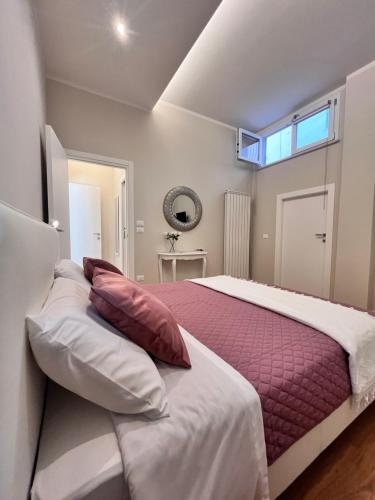 a bedroom with a bed with pillows and a window at Relax House CityCenter in Pescara