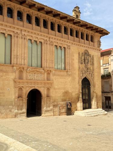 a large brick building with a statue on the front at Casa Rosetta Boutique in Xàtiva