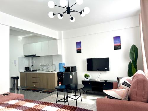 a living room with a couch and a table and a kitchen at Zen Studio for your Rest and Unwind in Nairobi