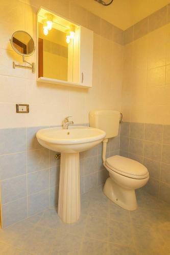 a bathroom with a sink and a toilet at Al Palmento Relais in Siracusa