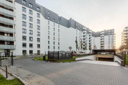 a large white building with a walkway in front of it at Enjoy! Ursus in Warsaw
