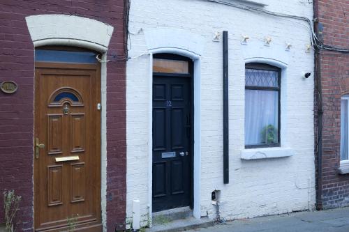 two doors on the side of a brick building at 2 Bedroom house 12 Rutland in Dublin