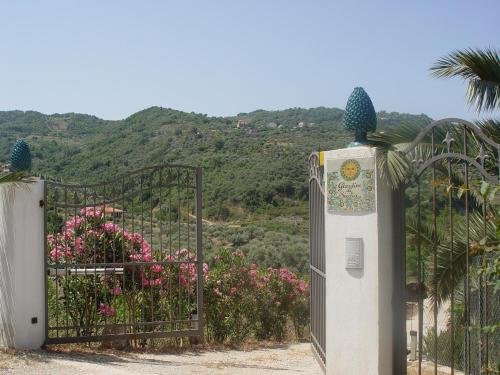 an open gate with a view of a mountain at Giardino Di Sicilia in SantʼAgata di Militello
