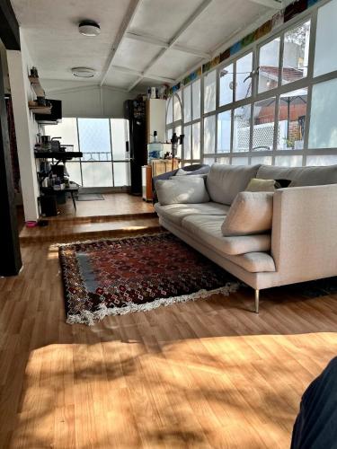 a living room with a couch and a rug at Beautiful Loft 10 minutes from AIFA in San Pedro Atzompa