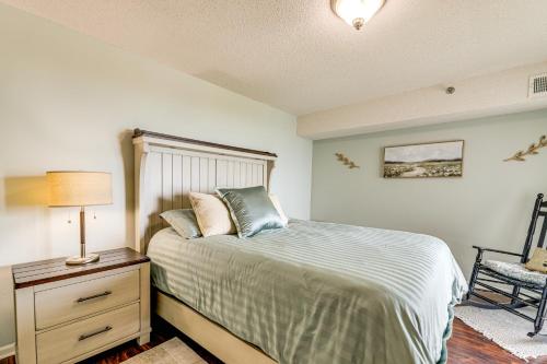1 dormitorio con cama, lámpara y silla en N Topsail Beach Oceanfront Condo with Pool!, en North Topsail Beach
