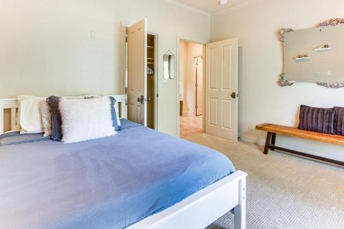 a bedroom with a bed and a mirror and a bench at Hot Tub and Trail Access Treehouse in Landrum! in Landrum