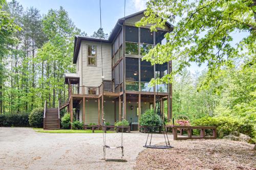 a house with two swings in front of it at Hot Tub and Trail Access Treehouse in Landrum! in Landrum
