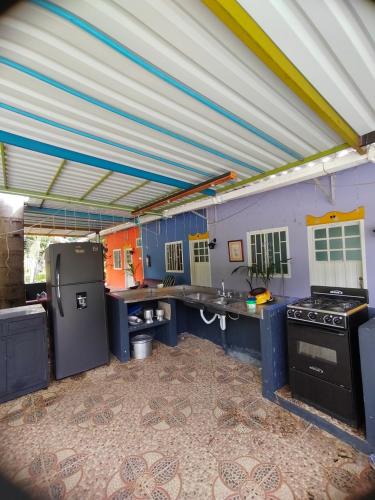 a large kitchen with blue counters and appliances at Estancia Colibrí in Ricaurte