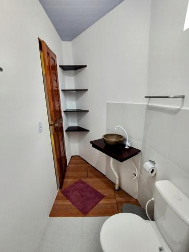 a bathroom with a toilet and a bowl on a table at Pousada Chacara Cururu in Alter do Chao