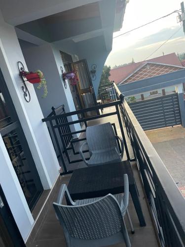two chairs and a table on a balcony at Meskel Homes in Mukono