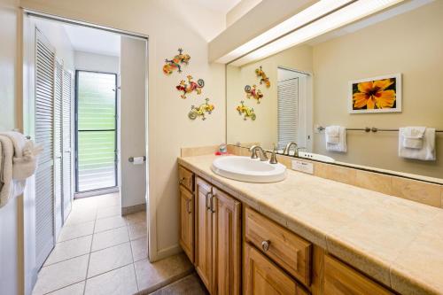 a bathroom with a sink and a mirror at Big Island Keauhou Punahele B108 by Coldwell Banker Island Vacations in Kailua-Kona