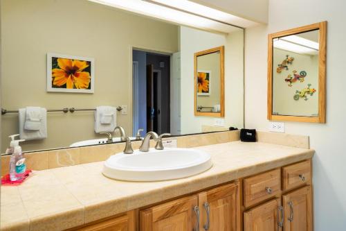 a bathroom with a sink and a large mirror at Big Island Keauhou Punahele B108 by Coldwell Banker Island Vacations in Kailua-Kona