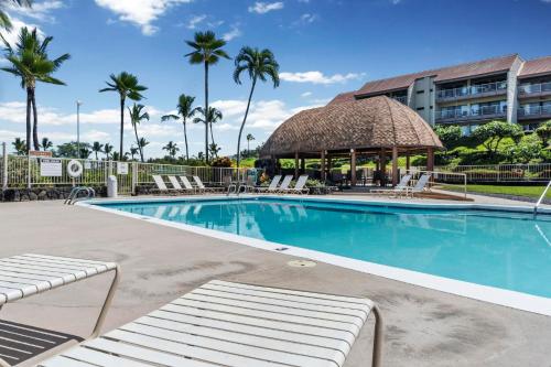 a swimming pool with a gazebo and palm trees at Big Island Keauhou Punahele B108 by Coldwell Banker Island Vacations in Kailua-Kona