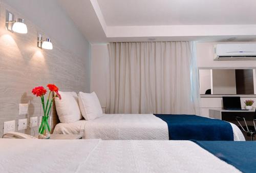 Postel nebo postele na pokoji v ubytování Kasa Hotel & Suites