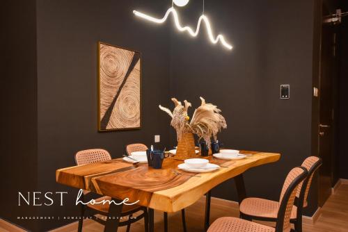 a dining room with a wooden table with chairs at Country Garden Seaview Suite by Nest Home at Danga Bay in Johor Bahru
