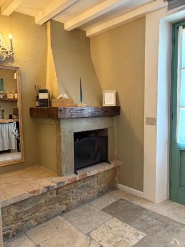 a fireplace in the corner of a room at CASA VASARI Holiday Suites TUSCANY in Lucignano