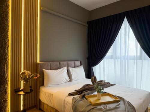 a hotel room with a bed with a tray on it at Country Garden Seaview Suite by Nest Home at Danga Bay in Johor Bahru