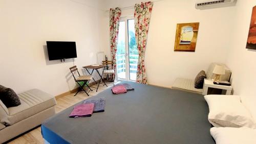 a living room with a couch and a table at Karavaki apartments in Keri