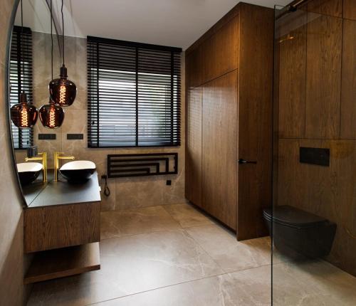 a bathroom with two sinks and a mirror at Unique House for Football Fans-Wroclaw Final- near Stadium in Wrocław