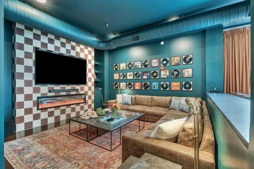 a living room with a couch and a tv at Nashville Studio B Suite 4BR by Maddox Hotel in Nashville
