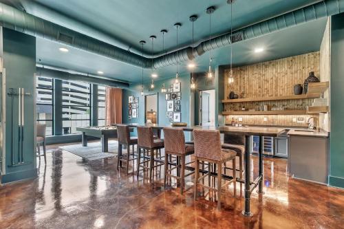 a kitchen with a long table and chairs at Nashville Studio B Suite 4BR by Maddox Hotel in Nashville
