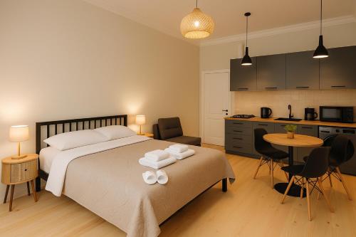a bedroom with a bed with two towels on it at Poti Seaside Apartment O in Poti