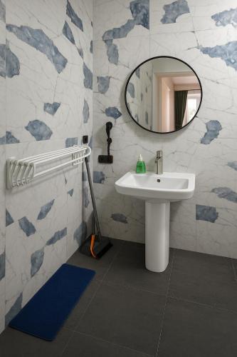 a bathroom with a sink and a mirror at Poti Seaside Apartment O in Poti