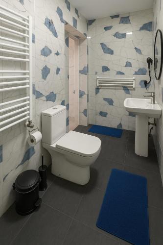 a bathroom with a toilet and a sink at Poti Seaside Apartment O in Poti