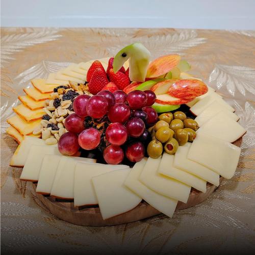 a plate of cheese and fruit on a table at Hotel Zensual in Bogotá