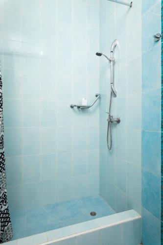 a bathroom with a shower with a tub and a sink at 2BD Spacious Apartment with Front Terrace and Country Views - Gozo Island in Qala