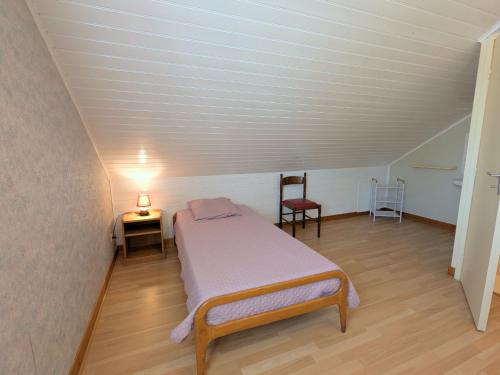 a small bedroom with a bed and a chair at Gîte au bord de la Creuse avec parking privé à Ceaulmont - FR-1-591-736 in Ceaulmont