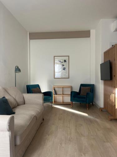 a living room with a couch and two chairs at AL 31 Bg in Bergamo