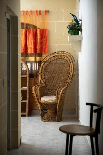 a room with two wicker chairs and a window at 2BD Spacious Apartment with Front Terrace and Country Views - Gozo Island in Qala