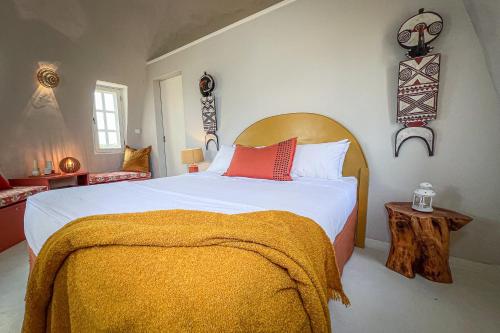 a bedroom with a large bed with a orange blanket at Humbi Farm in Xai-Xai
